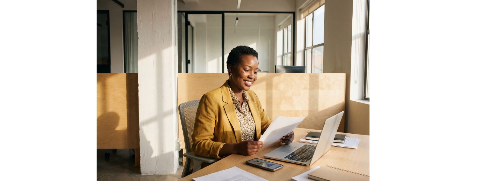 Business owner reviewing documents at organized workstation